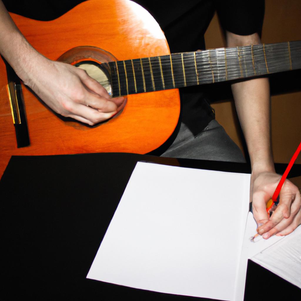 Man playing guitar, writing music